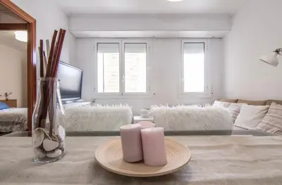 a living room with two candles on a table at Nordic Apartment II Sagrada Familia in Barcelona