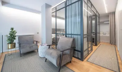 a living room with two chairs and a table at Poble Nou II You Stylish Apartments in Barcelona