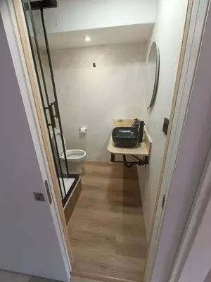 a hallway leading to a bathroom with a toilet at Sol & Relax en centro, Sitges. in Sitges