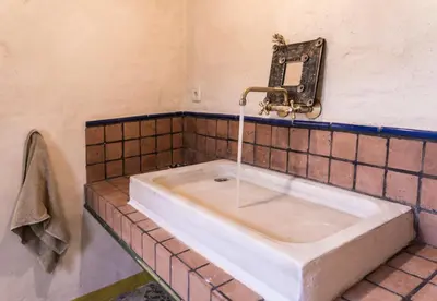 a bathroom with a white sink and austed at Masia Mediterranian Country House Ca l'Isidre Torrent in Sant Cebrià de Vallalta