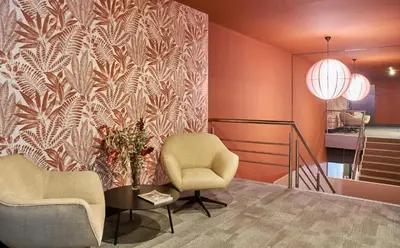 a living room with two chairs and a table and a wall at The Moods Oasis in Barcelona