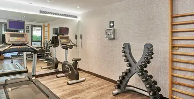 a gym with treadmills and cardio equipment in a room at The Moods Oasis in Barcelona
