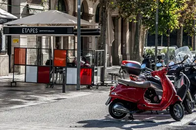 a red scooter parked on the side of a street at Habitat Apartments Rambla Deluxe in Barcelona