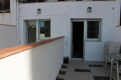 a white building with a counter and a table at Hostal Cal Siles in El Prat de Llobregat