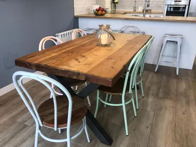 a wooden table with chairs and a jar on top at Vilamarlux III in Vilassar de Mar