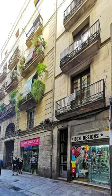 a building with balconies and a store on a street at ClassBedroom Gothic Ramblas Apartments in Barcelona
