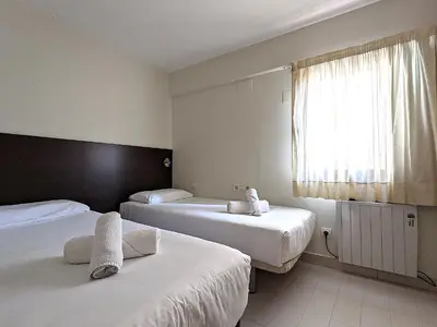 a hotel room with two beds and a window at ClassBedroom Gothic Ramblas Apartments in Barcelona