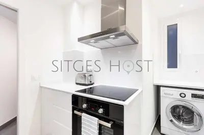 a kitchen with a sink and a stove top oven at Magnificas vistas al mar in Sitges