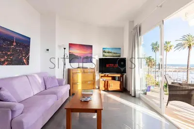 a living room with a purple couch and a tv at Magnificas vistas al mar in Sitges