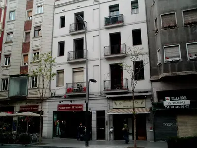 a tall white building with balconies on a city street at Mejor Apartamento en Plaza España con Parking Gratuito in Barcelona