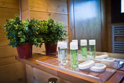 a counter with three bottles of alcohol and a potted plant at Refugio cálido,estilo nórdico el Bosquet in Sant Cugat del Vallès