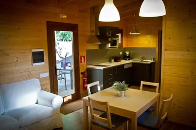 a kitchen and dining room with a table and a couch at Refugio cálido,estilo nórdico el Bosquet in Sant Cugat del Vallès