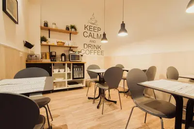 a restaurant with tables and chairs in a room at Hostal Live Barcelona in Barcelona