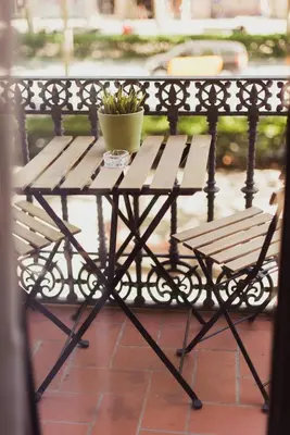 a wooden table with a potted plant on top of it at Hostal Live Barcelona in Barcelona