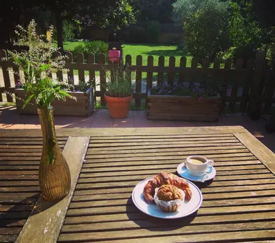 a table with a plate of food and a cup of coffee at Ca L'Estrada in Sant Esteve de Palautordera