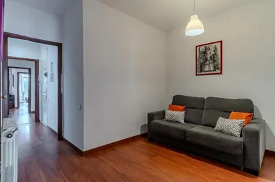 a living room with a couch and a hallway at AB Passeig de Gràcia Còrsega in Barcelona