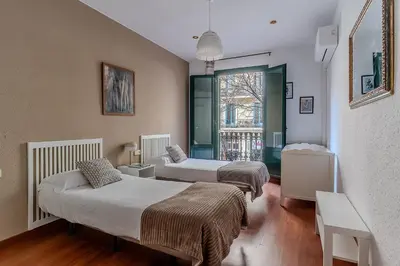 two beds in a room with a window at AB Passeig de Gràcia Còrsega in Barcelona
