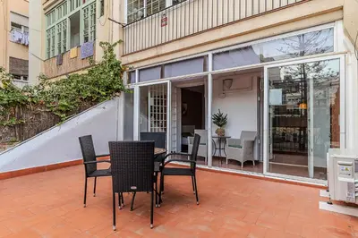 a patio with a table and chairs in front of a building at AB Passeig de Gràcia Còrsega in Barcelona