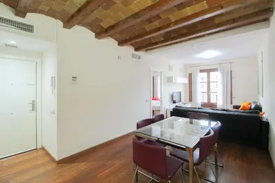 a living room with a glass table and chairs at Girona 108 in Barcelona