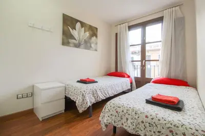a bedroom with two beds and a window at Girona 108 in Barcelona
