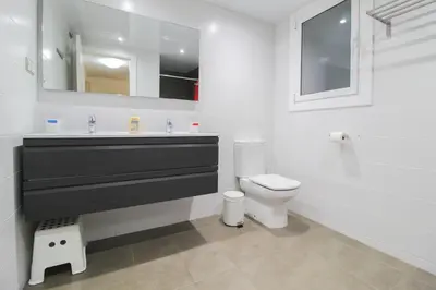 a white bathroom with a sink and a toilet at Girona 108 in Barcelona