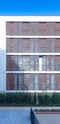 a large building with windows and a fence in front of it at Hotel Raval House in Barcelona