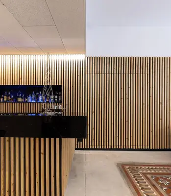 a bar in a room with a wooden wall at Hotel Raval House in Barcelona