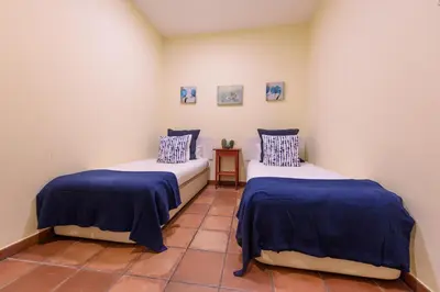 two beds with blue and white sheets in a room at RamblasRentals Chic & Spacious Flat Pool Table 15M Ramblas - Parking - Wifi in Barcelona