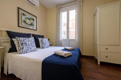 a bedroom with a bed with two towels on it at RamblasRentals Design Renovated Apartment AC Balcony10m Ramblas - Parking - Wifi in Barcelona