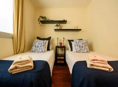 two beds in a room with towels on them at RamblasRentals Stylish Bright 3BR New Catalan Flat 10m Ramblas - Parking - Wifi in Barcelona