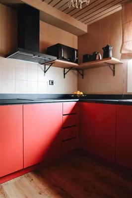 a kitchen with red cabinets and black counter tops at Isabella's House in Barcelona