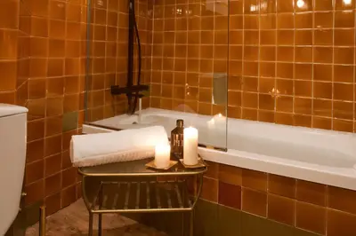 a bathroom with a table with two candles and a tub at Isabella's House in Barcelona