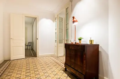 a hallway with a dresser and a hallway with a door at b42 - MODERNIST APARTMENT FOR LARGE GROUPS IN EIXAMPLE in Barcelona