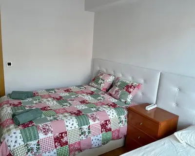 a bedroom with a bed with a quilt on it at Amplio Apartamento cerca de FIRA y del Centro in Hospitalet de Llobregat