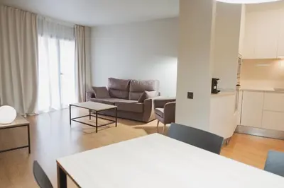 a living room with a couch and a table at Apartments Hotel Sant Pau in Barcelona