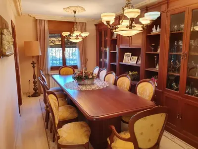 a dining room with a wooden table and chairs at Cal Llopet in Can Cartro
