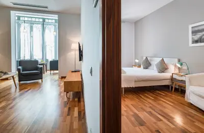 a bedroom with a bed and a living room at Habitat Apartments Alibei in Barcelona