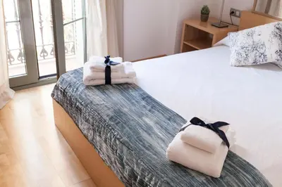 a bedroom with a bed with towels on it at Habitat Apartments Alibei in Barcelona