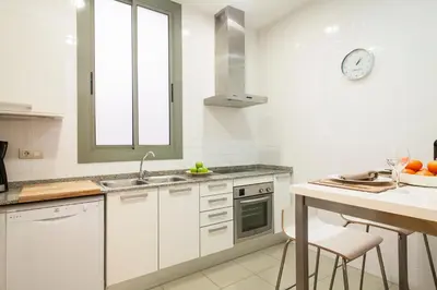 a white kitchen with a sink and a counter at Habitat Apartments Alibei in Barcelona