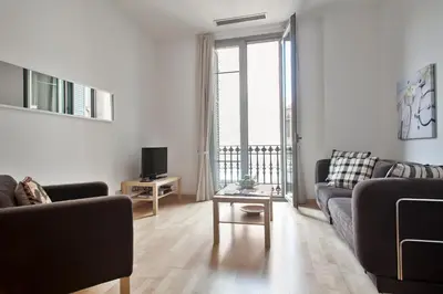 a living room with a couch and a tv at Habitat Apartments Alibei in Barcelona