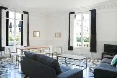 a living room with couches and tables and windows at My Address in Barcelona in Barcelona