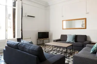 a living room with two couches and a tv at My Address in Barcelona in Barcelona