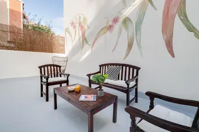 a room with three chairs and a table with a painting on the wall at Sweett - Verdi in Barcelona