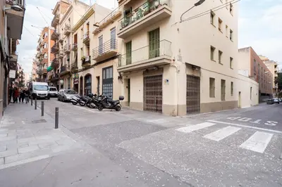 an empty city street with motorcycles parked on the sidewalk at Sweett - Verdi in Barcelona