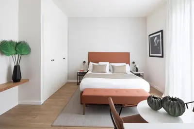 a bedroom with a bed and a table at Murmuri Residence Concepció in Barcelona