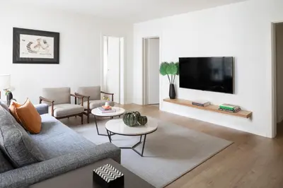a living room with a couch and a flat screen tv at Murmuri Residence Concepció in Barcelona
