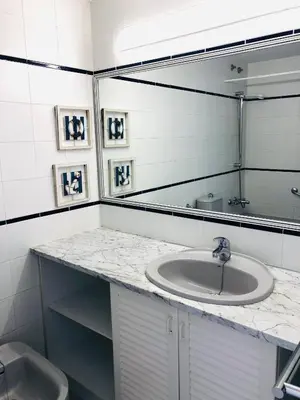 a bathroom with a sink and a mirror at La Marina SeaView Penthouse in Sitges