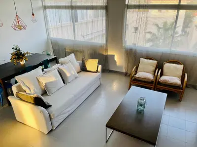 a living room with a white couch and a table at La Marina SeaView Penthouse in Sitges