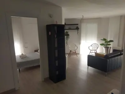 a living room with a couch and a chair at Luxury Apartment Accommodation, next to beach & train station Calella in Calella