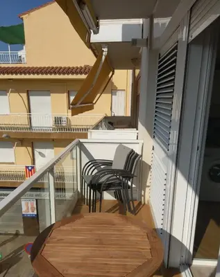a balcony with two chairs and a table at Luxury Apartment Accommodation, next to beach & train station Calella in Calella